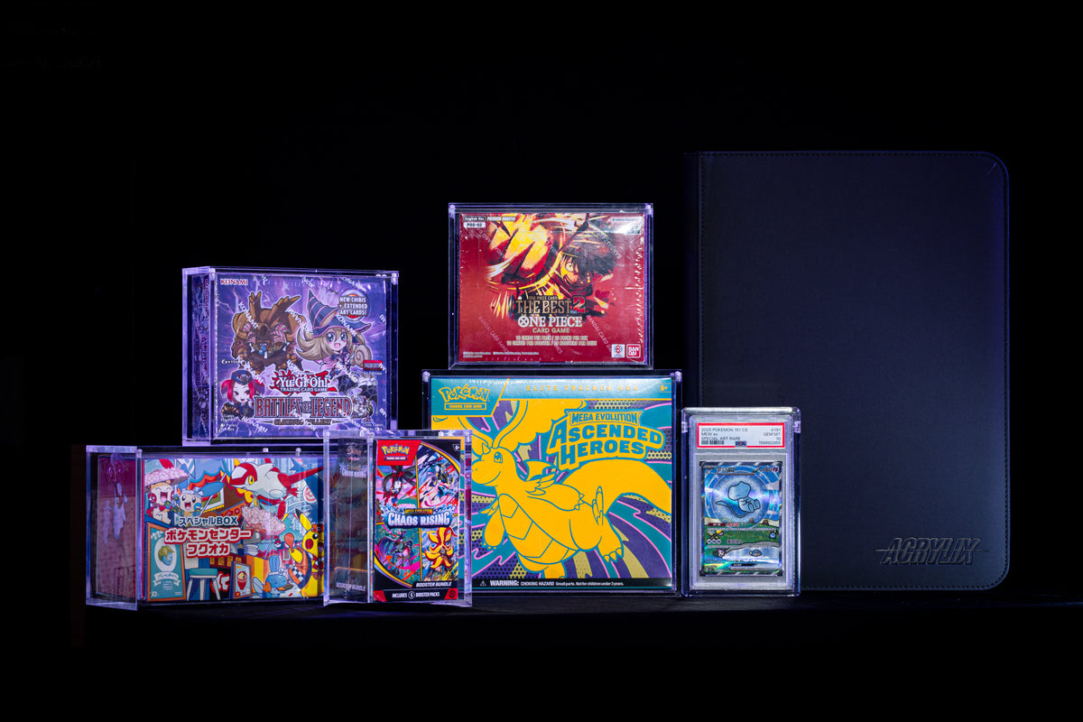 ACRYLIX™ acrylic cases holding One Piece, Pokémon and Yu-Gi-Oh! boxes beside a graded card case and a black zip binder