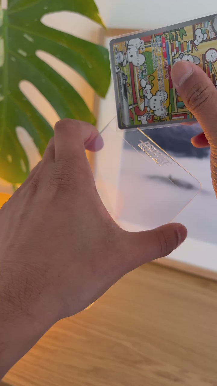 Sleeved trading card going into a semi-rigid grading holder, then held up – ACRYLIX