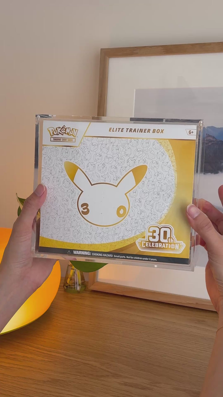 Pokémon Elite Trainer Box acrylic case holding 30th Celebration, held in hand – ACRYLIX