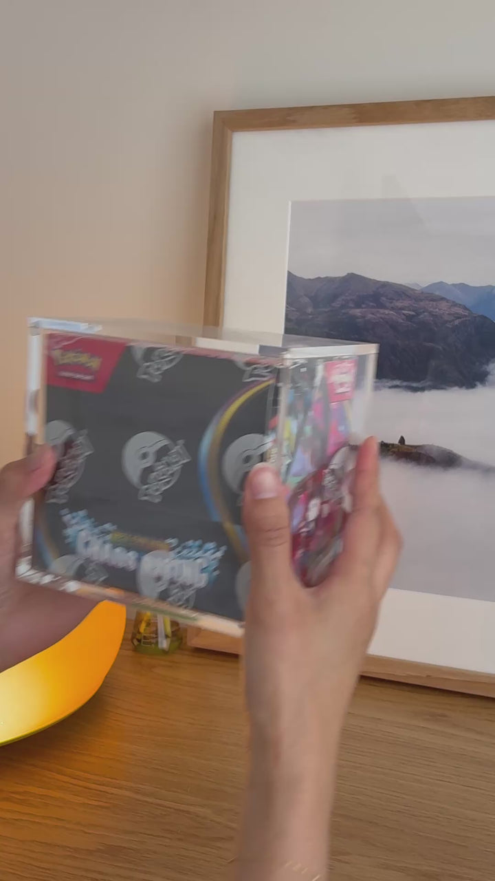 Pokémon booster box acrylic case holding Chaos Rising, held in hand – ACRYLIX